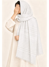 White Turkish lawn scarf with subtle grey stripes and fringed edges by Hijab ul Hareem, worn as a hijab